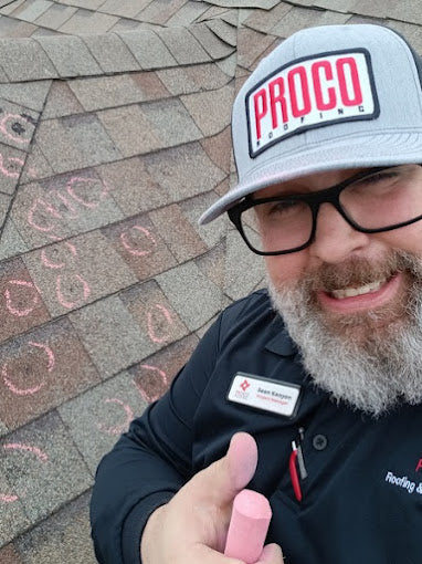 friendly PROCO roofer inspecting damage caused by hail